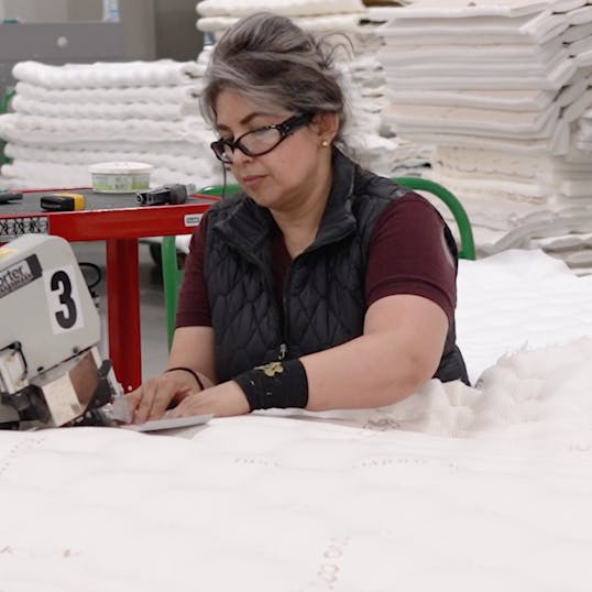 Woman working on a Saatva mattress